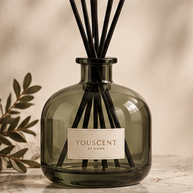 The Olive reed diffuser, muted olive glass. a timeless silhouette. Label saying Made yours.