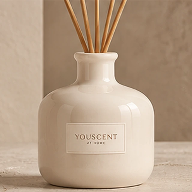 The Pearl reed diffuser, glossy porcelain. soft, generous curves. Label saying Made yours.